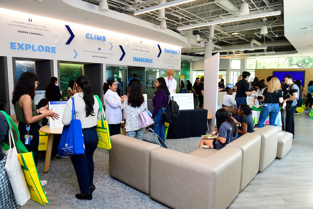 Attendees explore research posters, network, and enjoy refreshments in a lively exhibition area during the BioFestival event.