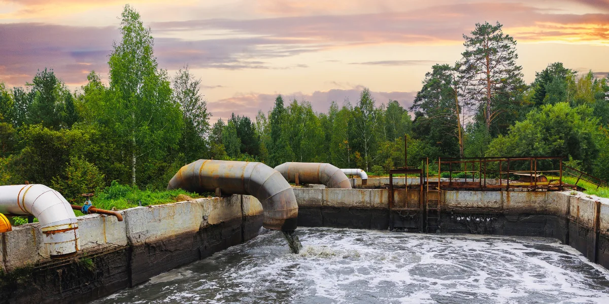 Pipes with waste water of industry is discharged into tank of treatment plant.
