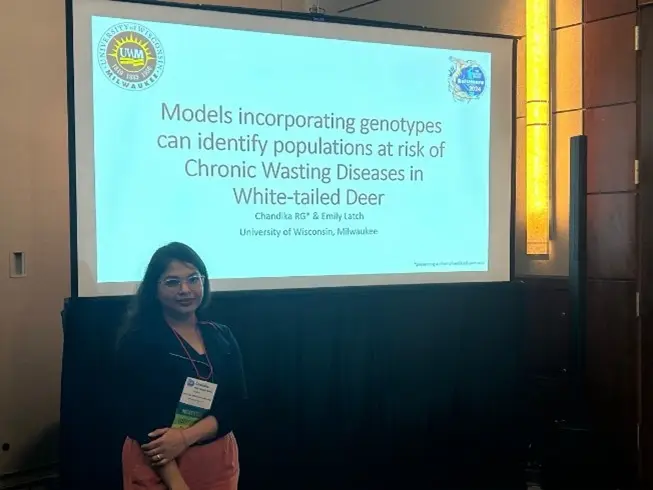 Woman presenting research on models identifying populations at risk of chronic wasting disease in white-tailed deer
