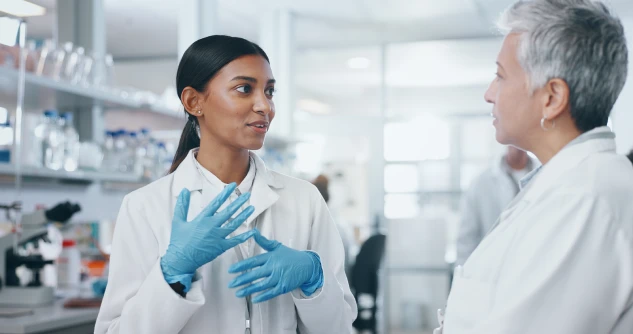 Two scientists having a discussion in a science lab