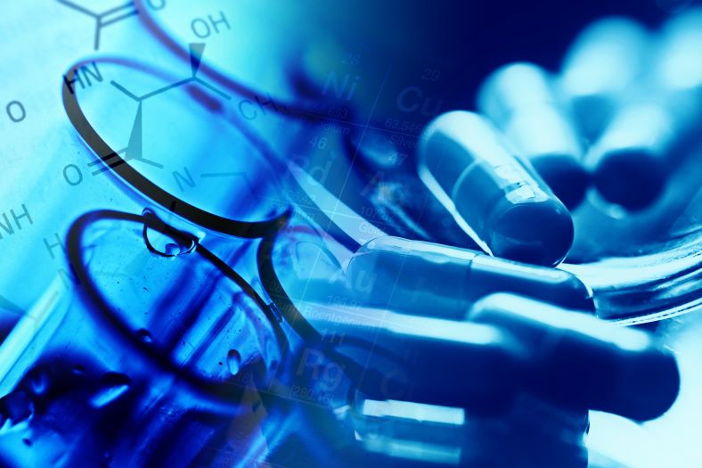 A close-up of laboratory glassware, molecular structures, and capsules, symbolizing pharmaceutical research and development.