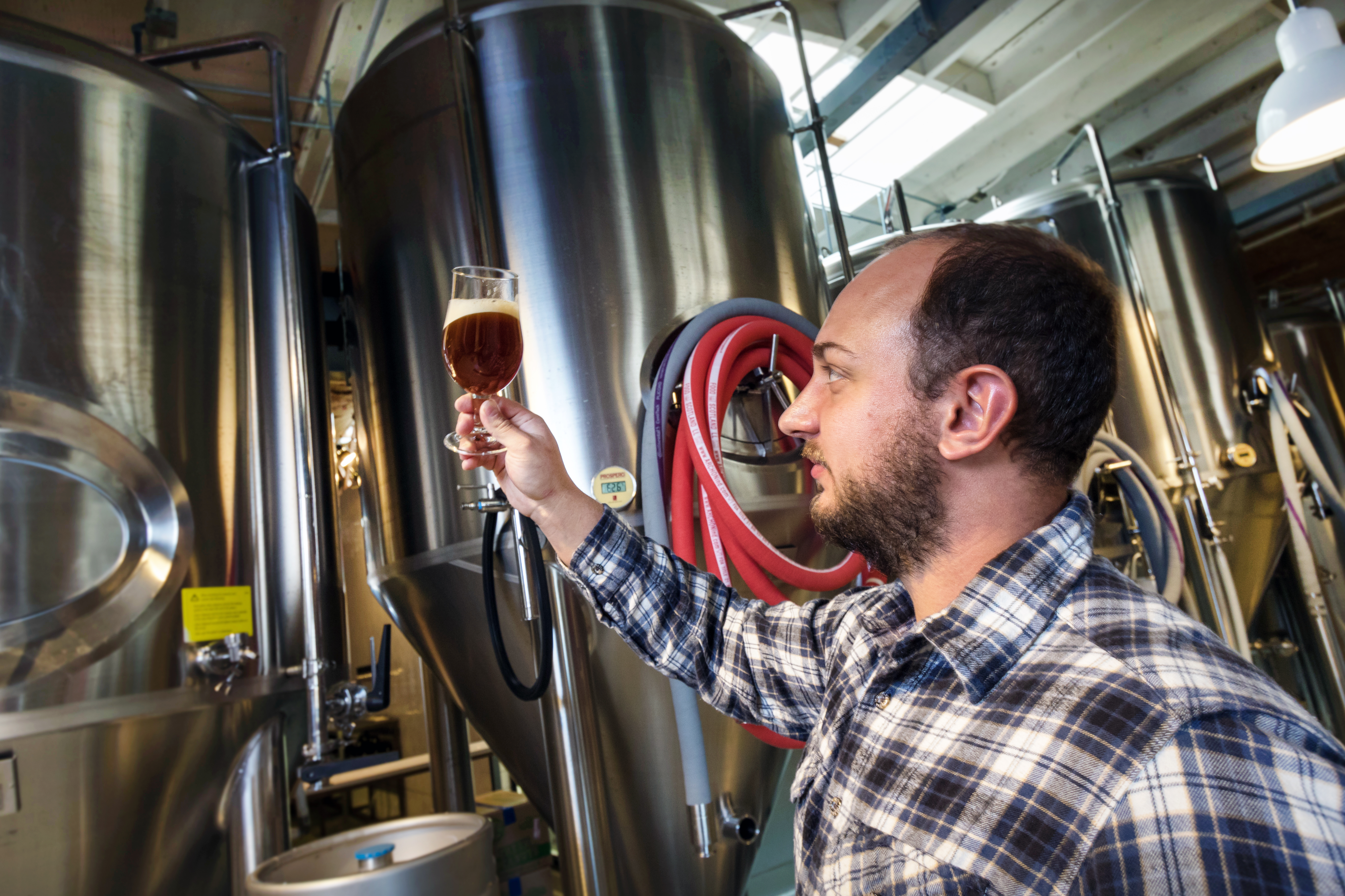 man holding a beer up