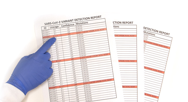 Glove covered hand is pointing to the spreadsheet reports