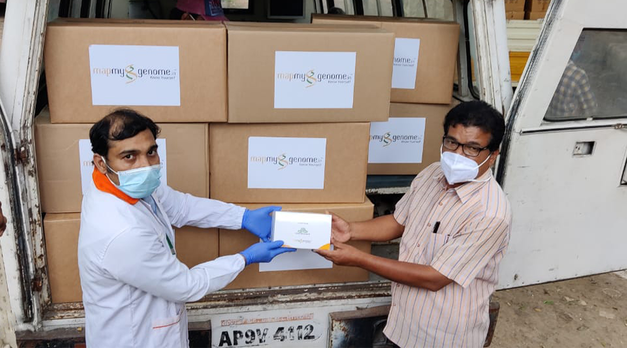 Image of two people unloading a van full of DNA/RNA Shield - DirectDetect test kits.