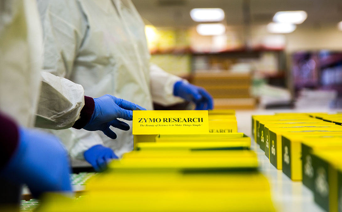 Zymo workers building kit boxes to ship to customers.