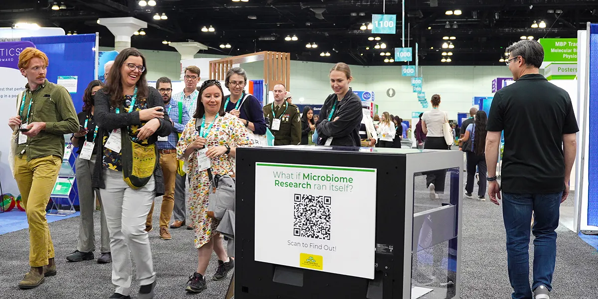 A remote-controlled MultiOmiX Workstation rolls into the Zymo Research booth at ASM 2025, drawing curious crowds with its rover-like entrance.