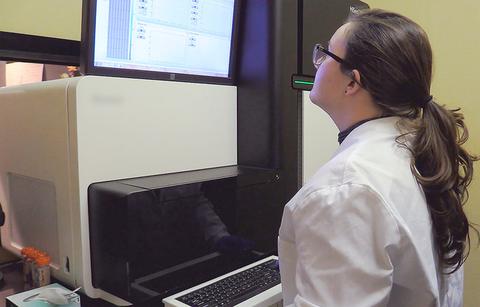 Scientist observing machine output