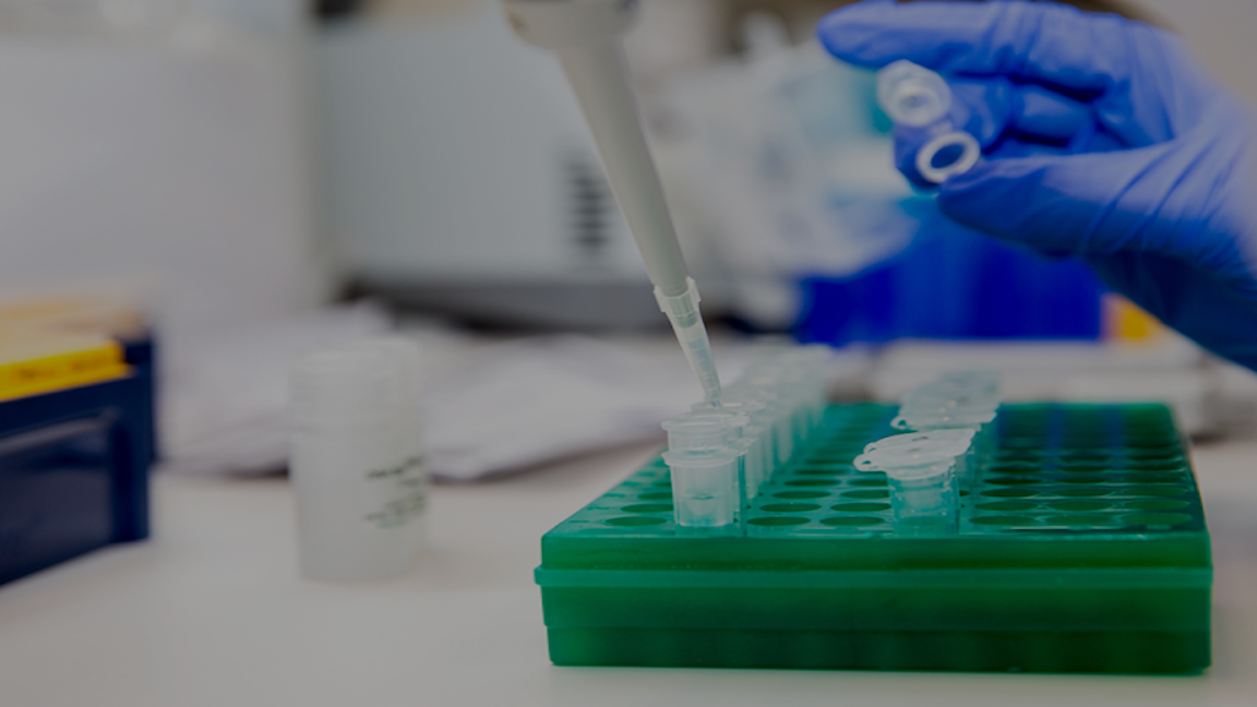 Scientist pipetting into microfuge tubes