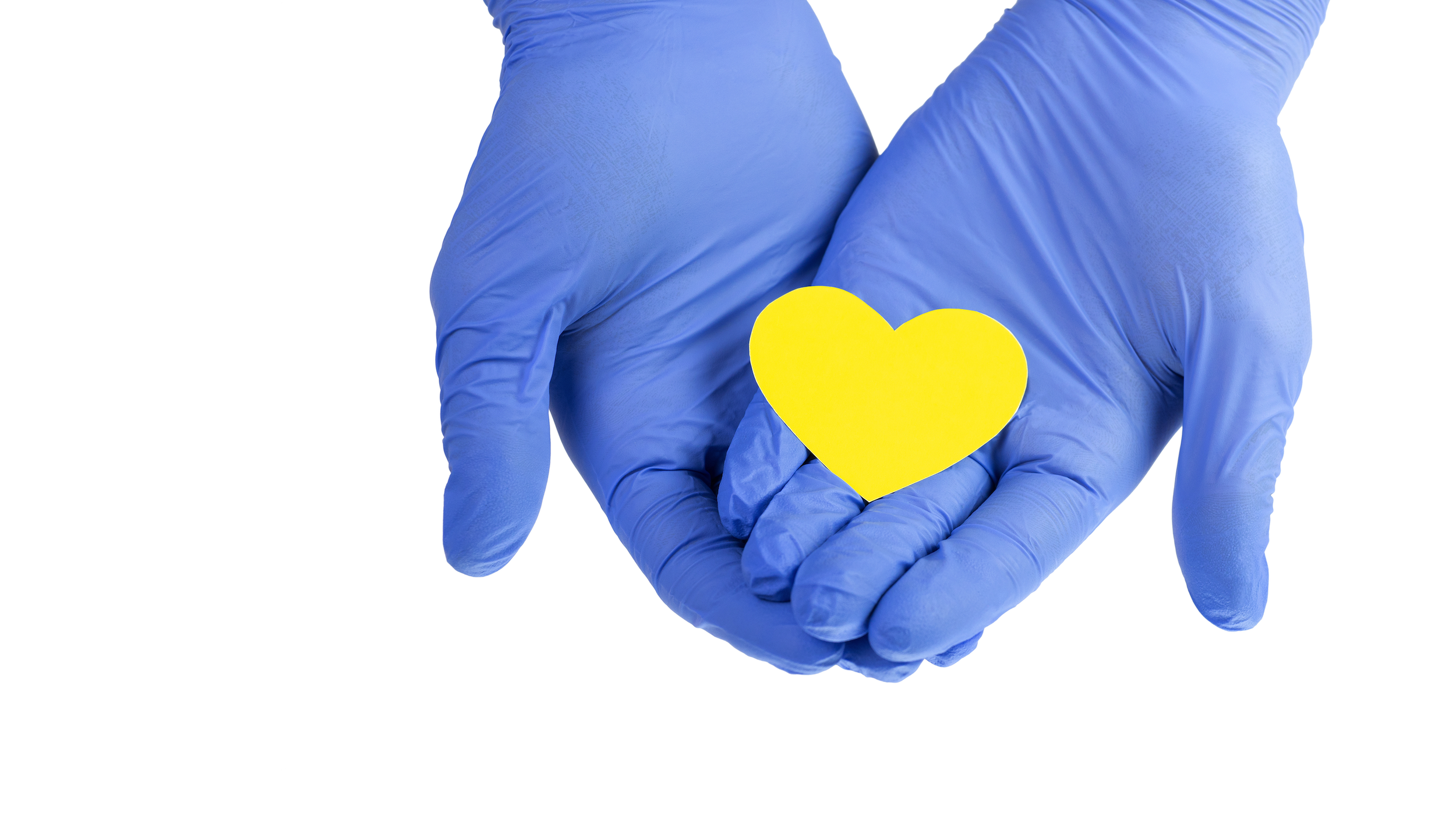 Rubber gloves holding yellow heart