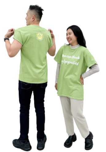 Two people wearing green shirts